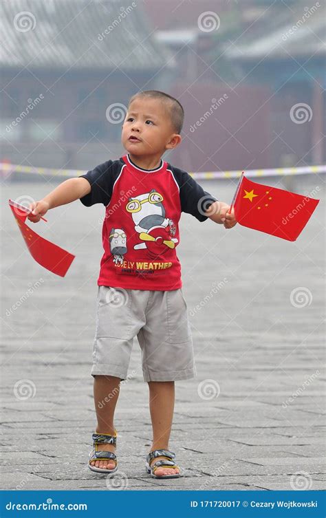 Chinese Boy With A Chinese Flag On The Streets Of Beijing Tiananmen