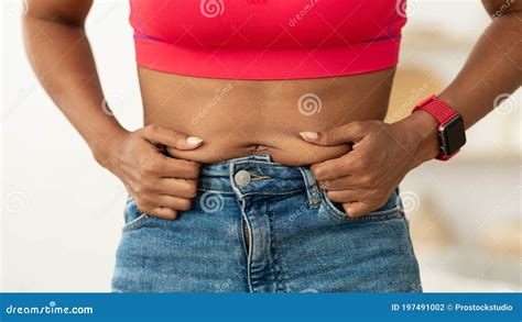 Unrecognizable African American Woman Touching Belly With Visceral Fat