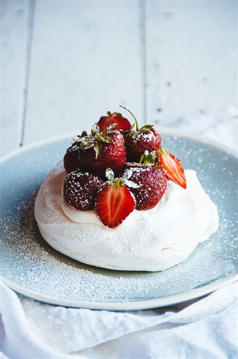 Cherry chocolate pavlova is a meringue dessert that's made of crispy on the outside and soft and fluffy as a cloud inside meringue disk, which is then topped with whipped cream and cherry sauce. Strawberries and Cream Pavlova | Hint of Vanilla
