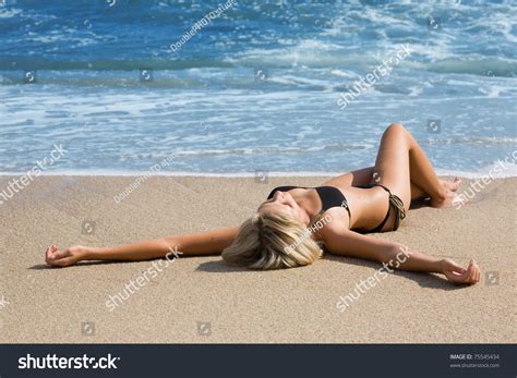 Sexy Girl In Bikini Lying On A Sandy Beach Stock Photo