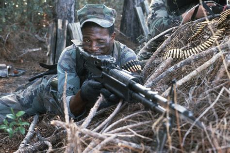 A United States Marine Fires An M60 Machine Gun From A Prone Position