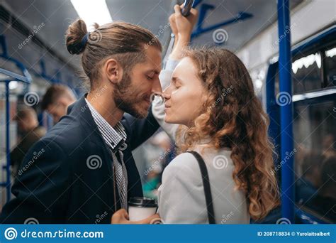 Man And Woman In Love Looking At Each Other On A Subway Train Stock