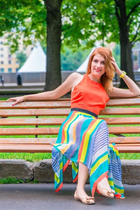 Woman In A Orange Dress On A Park Bench Stock Image Image Of Portrait