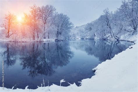 Winter Forest On The River At Sunset Panoramic Landscape With Snowy