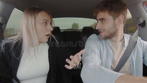 A Guy And A Girl Are Driving A Car And Arguing People In The Car Stock