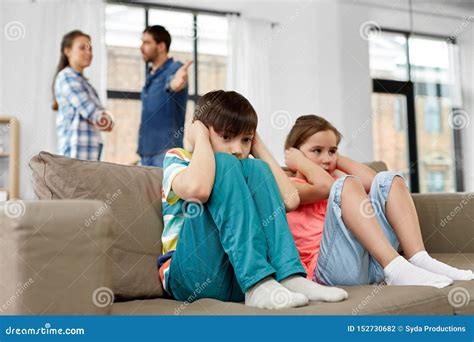 Sad Children And Parents Quarreling At Home Stock Photo Image Of