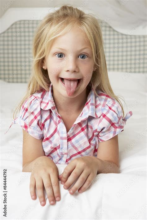 Babe Girl Lying On Bed Pulling Funny Face Stock Photo Adobe Stock