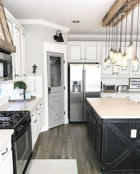 Because they aren't on full display, you don't have to white walls, stainless steel appliances, and lots of natural light brighten up this kitchen with black cabinets. 15 Gorgeous White Kitchens with Coloured Islands | The Happy Housie