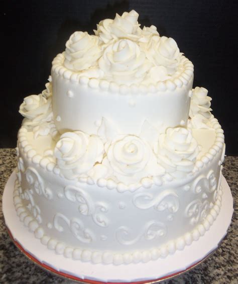 Both tiers are buttery, soft, and moist. Our traditional white buttercream iced cake decorated with ...
