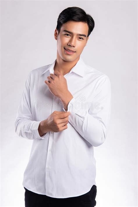 Handsome Confident Young Man Standing And Smiling In A White Shirt On