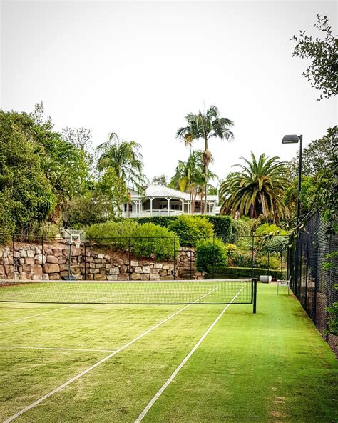 Tennis court with traditional home | Tennis court backyard, Tennis court design, Tennis court