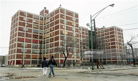 Two Residents Walk Past One Of The Few Remaining Chicago Housing
