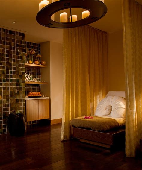 A Room With A Bed And Some Lights On The Wall Next To A Shelf That Has