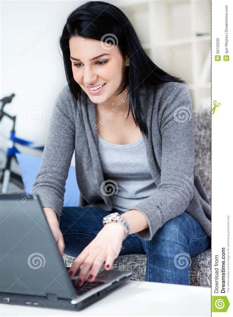 Young Woman Smiling While Using Laptop Stock Photo Image Of House
