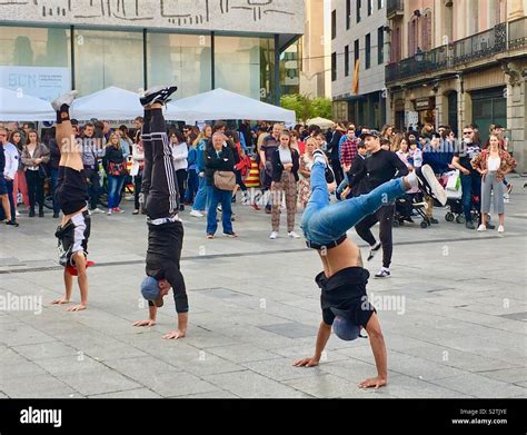 Three Street Performers Doing Handstands During A Dance Performance In