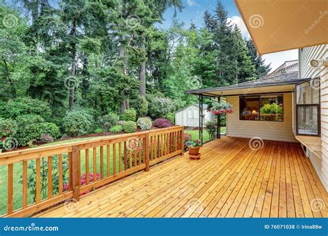 Wooden Walkout Deck Well Kept Garden With Bushes And Flowers Stock