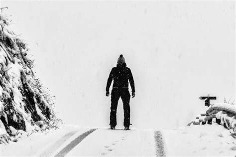 Man Standing On White Snow Covered Ground Beside Mountain · Free Stock