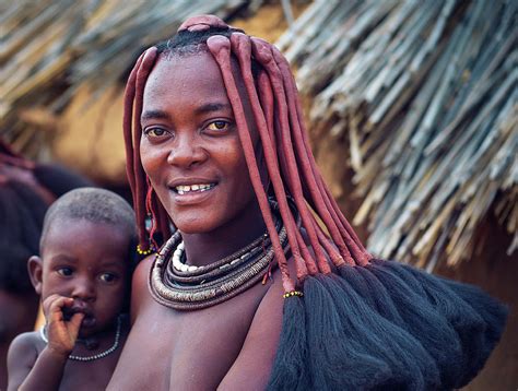 Portrait Of A Young Himba Woman With Her Child Wearing Traditional