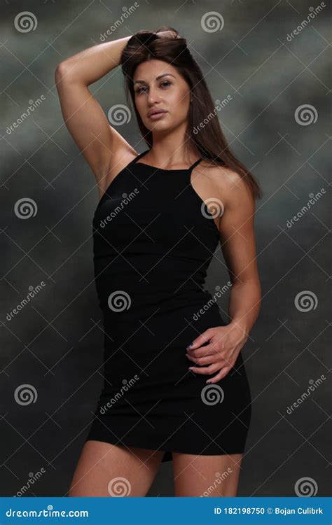 Attractive Muscular Brunette Caucasian Girl Posing In Studio On