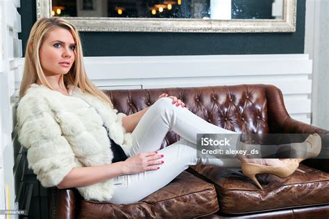 Stylish Woman Sitting On Leather Sofa Stock Photo Download Image Now