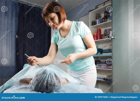 Redhead Masseur Does Massage Cream On The Woman Face Royalty Free Stock Image Image 29957686