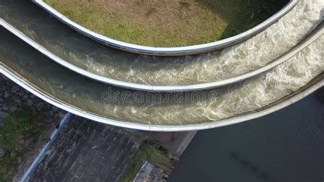 Aerial Water In Dam Concrete Spillway Infrastructure At Reservoir