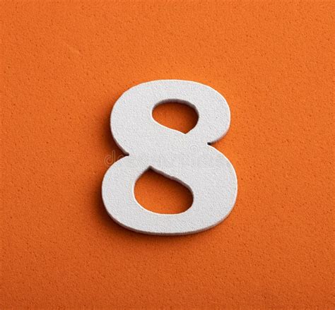 Number Eight White Number In Wood On Orange Background Stock Image