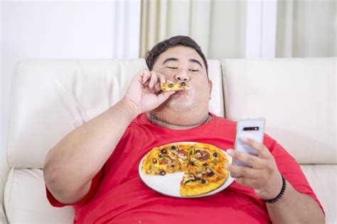 Fat Man Chewing Doughnuts In His Living Room Stock Photo Image Of