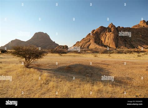 Savannah Landscape With Granite Rocks Of Spitzkoppe Mountain And The