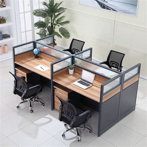 An Office Cubicle With Two Desks And Three Chairs One On The Other Side