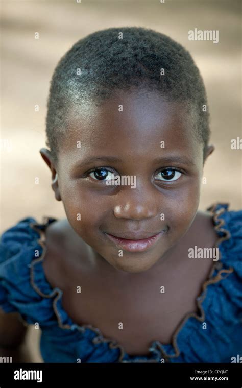 A Closeup Portrait Of A Female African Child Smiling At Camera Stock