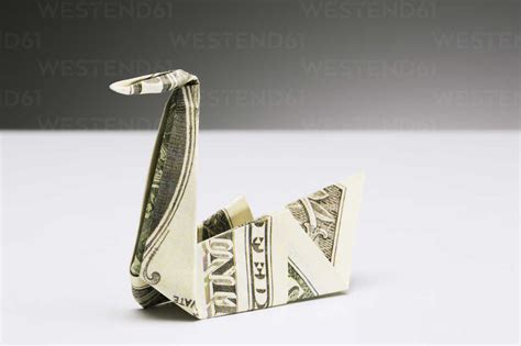 Origami Swan Made Of Dollar Bill On Counter Stock Photo