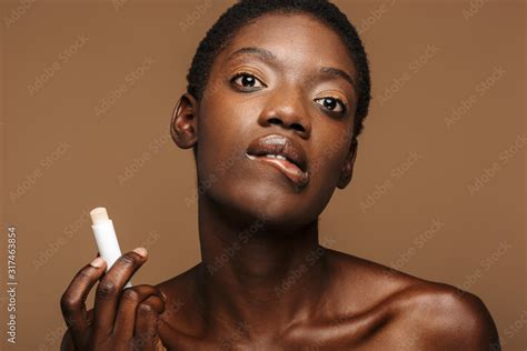Beauty Portrait Of Young Half Naked African Woman Putting On Lipbalm