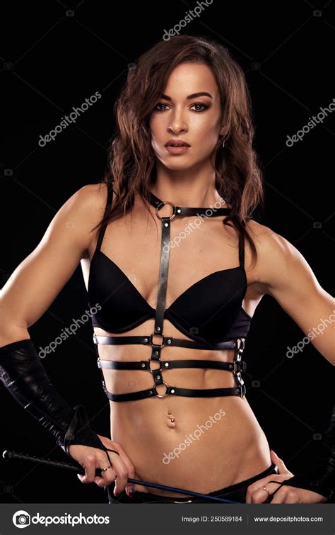 Sensual Provocation Of A Sexy Woman With Whip On Black Background Bdsm