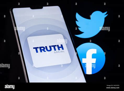 Truth Social App Logo Seen On The Smartphone With Blurred Facebook And