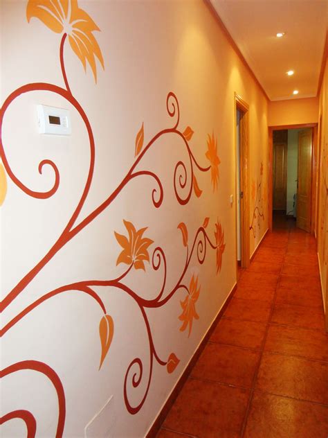 The Hallway Is Decorated With Orange And Brown Leaves On Its Wall