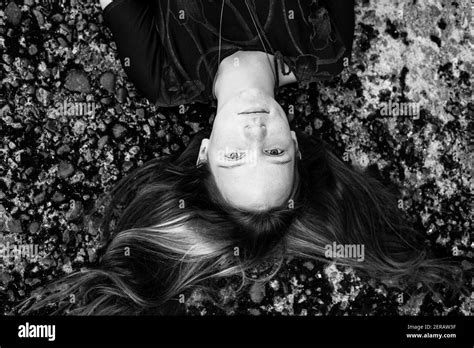 Top View Portrait Of A Girl Lying On The Ground Black And White Photo