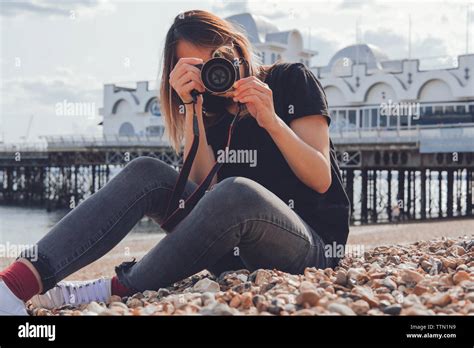 Asian Woman Taking Photos With Her Camera On The Beach Stock Photo Alamy