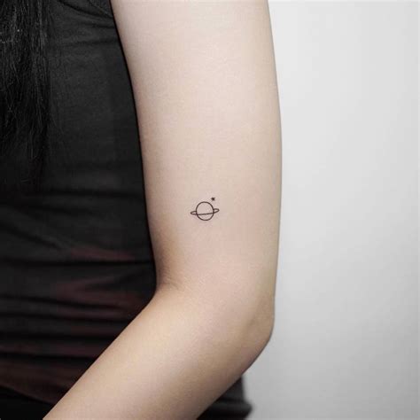 Minimalist Saturn Tattoo On The Upper Arm