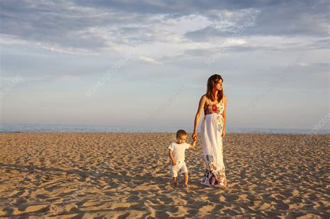 Mother And Toddler Walking Along Beach Stock Image F0097577