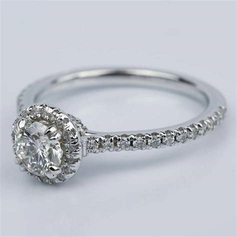 The most popular of all diamond shapes, the round brilliant is an enduring classic with the perfect balance of proportion and symmetry. Petite Halo Round Diamond Engagement Ring in White Gold (0.81 ct.)