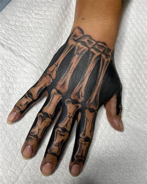 22 Amazing Skeleton Hand Tattoos That Are Scary And Attractive