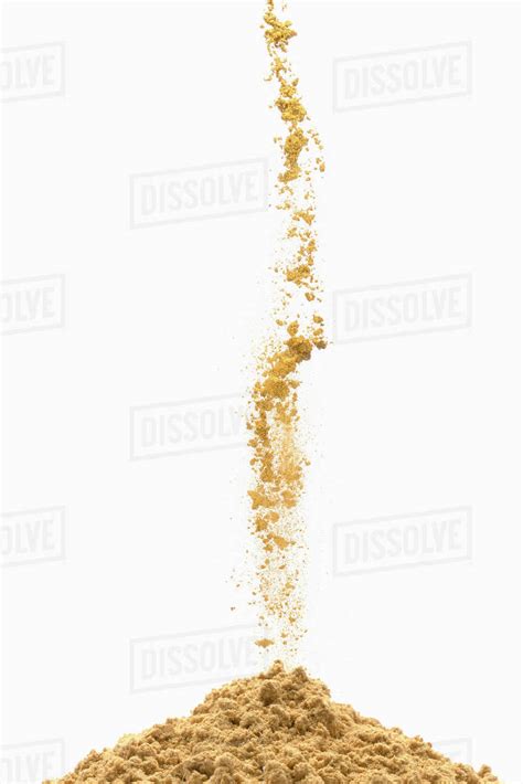 Brown Powder Pouring Into Pile Stock Photo Dissolve