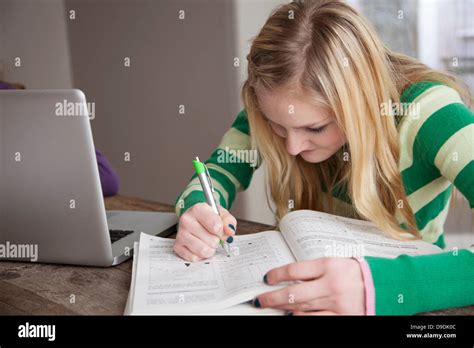 Girl Sitting At Table Studying Stock Photo Alamy