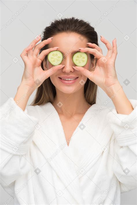 Beautiful Young Woman Holding Cucumber Slices Against Her Eyes Photo