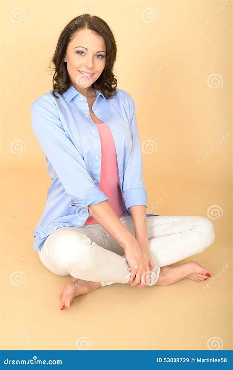 Young Happy Woman Sitting On Floor With Crossed Legs Stock Image