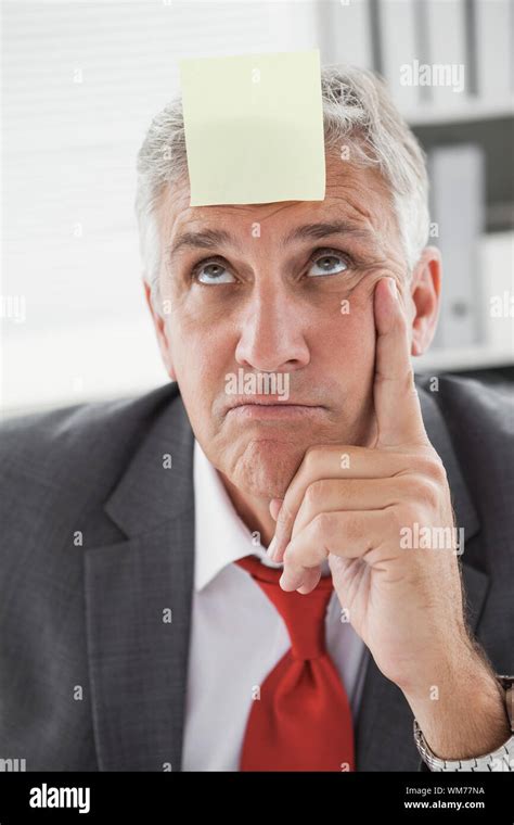 Confused Businessman With Sticky Note On Head In His Office Stock Photo Alamy