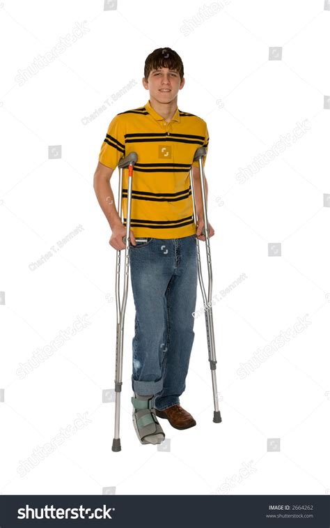 Teenage Boy On Crutches With His Right Foot In A Softcast Brace