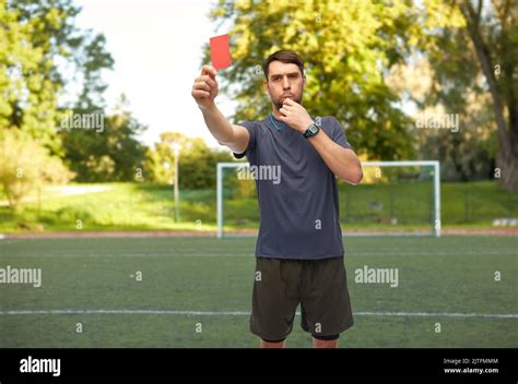 Soccer Referee Whistling And Showing Red Card Stock Photo Alamy
