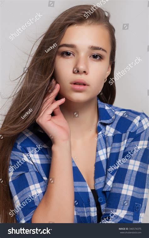 Cute Lady With Decollete Shirt White Wall As Background Stock Photo